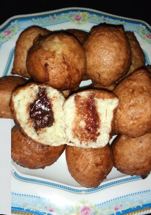 A picture of Puff puff filled with dark chocolate.
