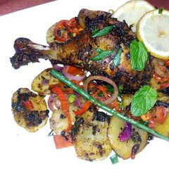 A picture of Grilled drum sticks and potatoes.