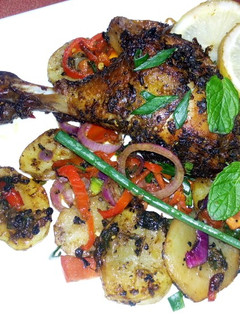 A picture of Grilled drum sticks and potatoes.