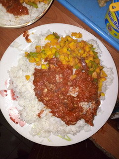 A picture of Rice with stew and carrots.
