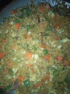 A picture of Fried couscous with veggies and proteins.
