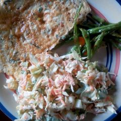 A picture of Coleslaw, omelette and veggies.