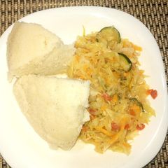 A picture of Ugali with cabbages with veg.