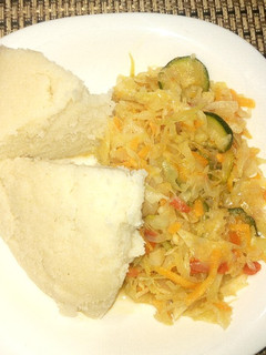 A picture of Ugali with cabbages with veg.