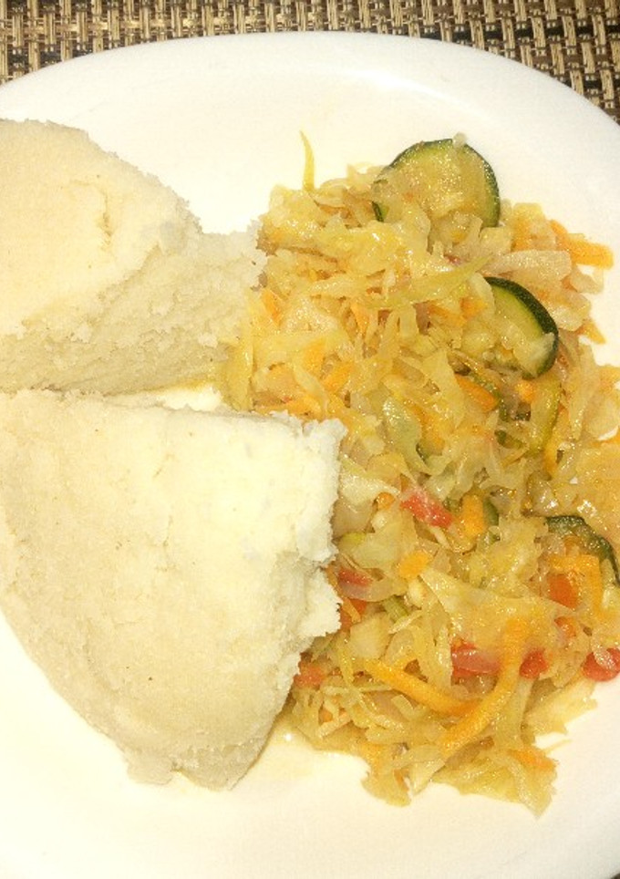 A picture of Ugali with cabbages with veg.