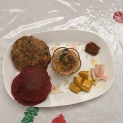 A picture of Colourful beet root and methi poori with aloo sabji.