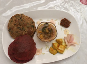 A picture of Colourful beet root and methi poori with aloo sabji.