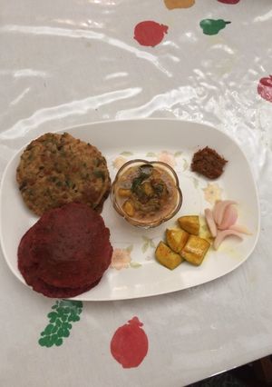 A picture of Colourful beet root and methi poori with aloo sabji.