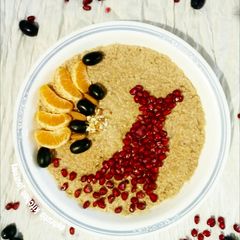 A picture of Chocolate flavoured oats with seasonal fruits and nuts.