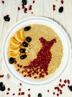 A picture of Chocolate flavoured oats with seasonal fruits and nuts.