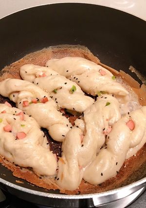 A picture of Pan-fried hotdog & spring onion rolls.