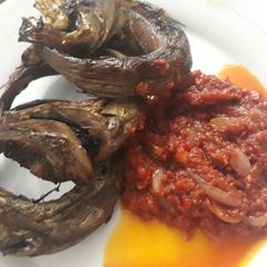 A picture of Grilled fish and pepper sauce.
