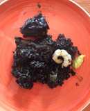 Arròs negre amb sèpia, conill i escarxofes