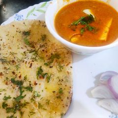 A picture of Paneer butter masala with Sesame butter Naan.