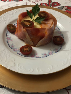Una foto de Timbal de puré de patata con lacón y tomate Cherry