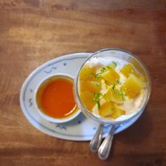 A picture of Mango mousse with fresh mango and passionfruit sauce.