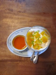 A picture of Mango mousse with fresh mango and passionfruit sauce.