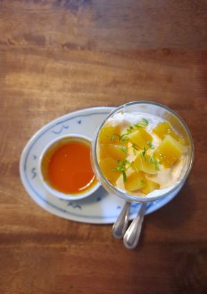 A picture of Mango mousse with fresh mango and passionfruit sauce.