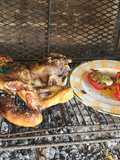 Pierna de cordero a la parrilla, acompañada de morrones rellenos de jamón, muzarella y huevo