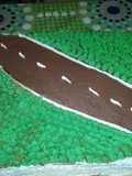 Torta de cumpleaños cuadrada pista de cars con pasto de crema