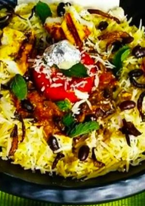 A picture of Saffron dum Biryani with Rajma curry.