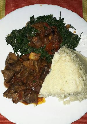 A picture of Liver fry ugali with veggies.