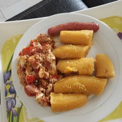 A picture of Boiled plantain with egg sauce and sausage.