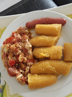 A picture of Boiled plantain with egg sauce and sausage.