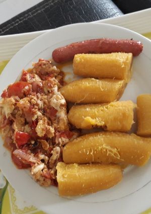 A picture of Boiled plantain with egg sauce and sausage.