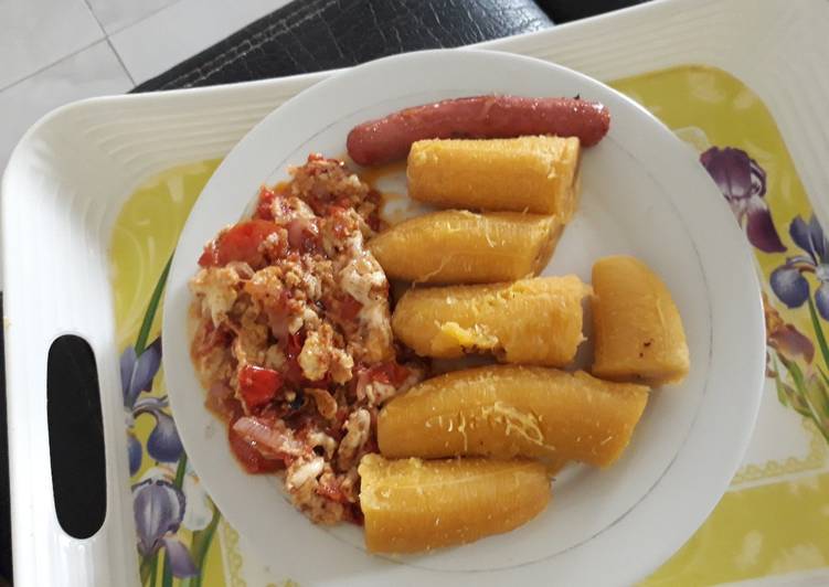 Boiled plantain with egg sauce and sausage