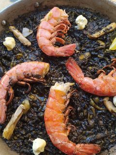 Una foto de Arroz negro con gambas, calamar, y sepia