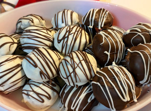 A picture of Gluten Free~ Almond and Cocoa Truffles covered in Vanilla or Milk Chocolate.