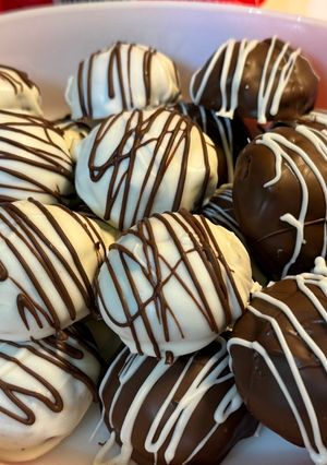 A picture of Gluten Free~ Almond and Cocoa Truffles covered in Vanilla or Milk Chocolate.