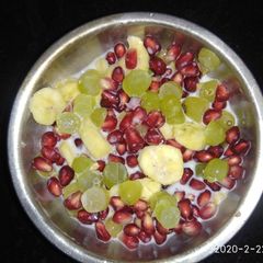 A picture of Grapes pomegranate banana custard.