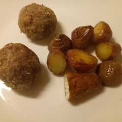 A picture of Speck and Parmesan meatballs with butter roasted potatoes.