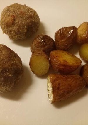 A picture of Speck and Parmesan meatballs with butter roasted potatoes.