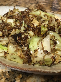 A picture of Sautéed cabbage with young sardine.