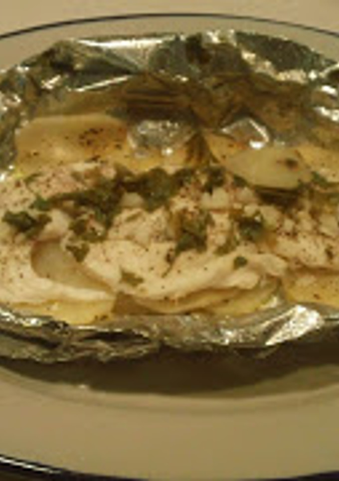 Una foto de Pescado empapelado con papas