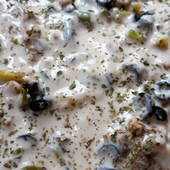A picture of Penne pasta with white sauce.