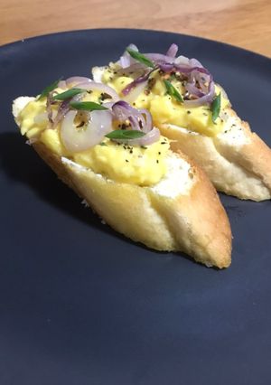 A picture of Egg Bruschetta With Cream Cheese And Saute Red Onions.