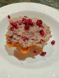 Risotto alla melagrana e speck su cialde di cestini al pecorino romano