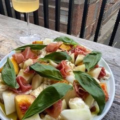 A picture of Simple melon, nectarine, mozzarella, Parma ham and basil salad.