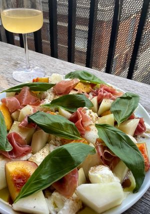 A picture of Simple melon, nectarine, mozzarella, Parma ham and basil salad.
