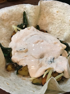 A picture of Vegetarian Delicious Wrap Roasted veggies & smoked paprika yogurt sauce.