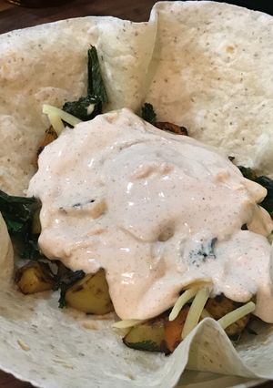 A picture of Vegetarian Delicious Wrap Roasted veggies & smoked paprika yogurt sauce.