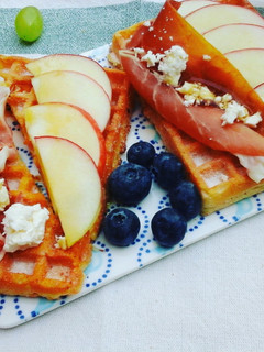 A picture of Breakfast waffles topped with prosciutto, apples, feta cheese & maple syrup.