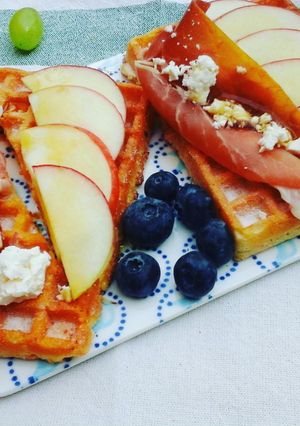 A picture of Breakfast waffles topped with prosciutto, apples, feta cheese & maple syrup.