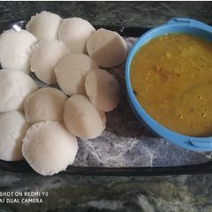 A picture of Hot steamed idli with sambhar.