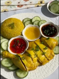 A picture of Hainanese Chicken with Yellow Rice.