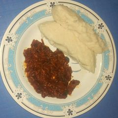 A picture of Ugali with fried fish curry.